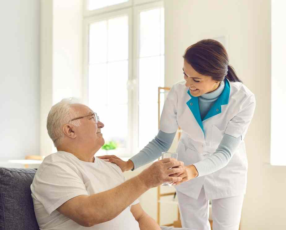 Homecare staff helping elderly man