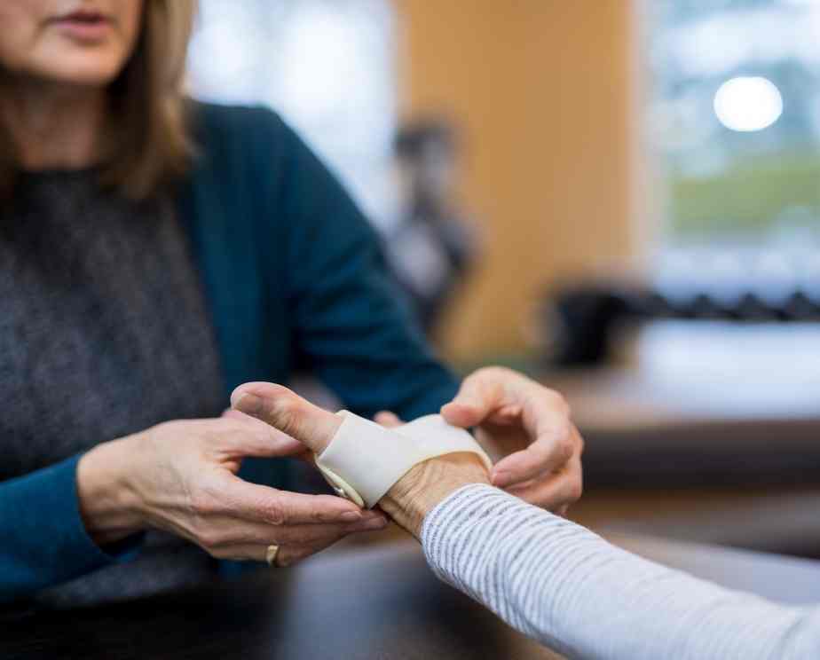 Occupational therapist helping an adult with their physical health