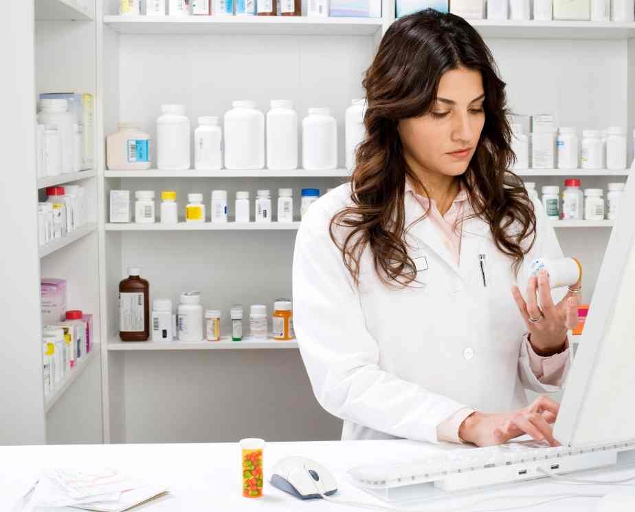 Pharmacist logging medication on the computer