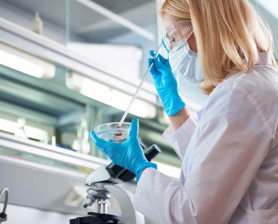 Biomedical scientist working with equipment